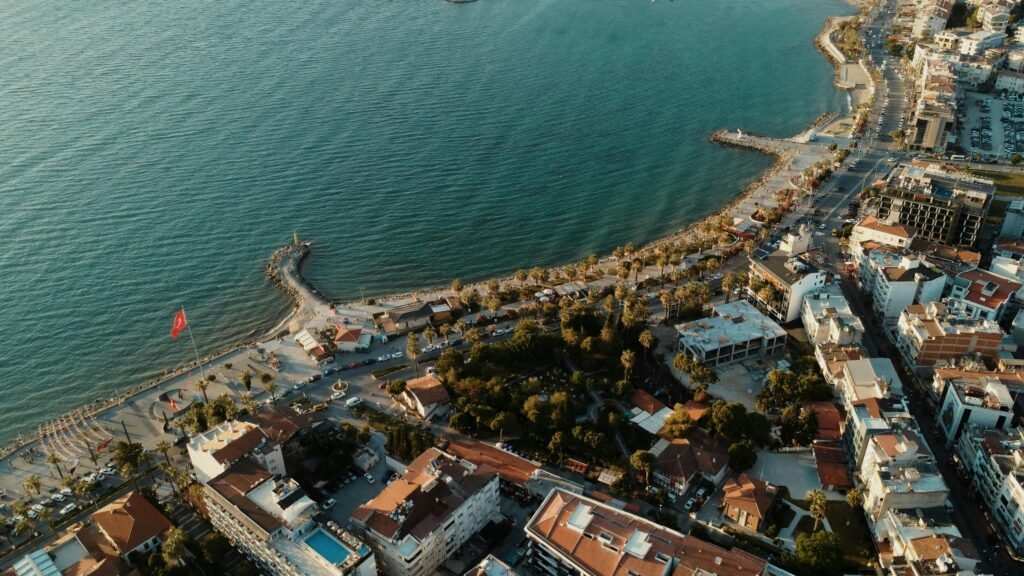 Stunning aerial cityscape of Kuşadası, showcasing the harbor, Mediterranean Sea, and urban areas.